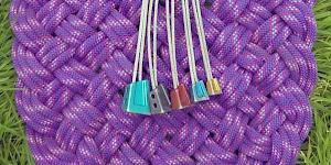 Image of a full set of DMM Alloy Offsets as used by the author, fanned out on a woven rope mat.