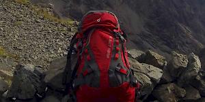 Image of a packed Deuter Guide Lite 32+ perched on the edge of the Cairn marking the base of the final ascent up Inaccessible Pinnacle.