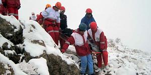 Mountain Rescue team evacuating a stretcher casualty off the mountain in snowy terrain.