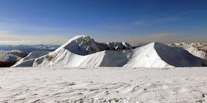View of Ben Nevis behind the Carn Mor Dearg arete from the summit of Aonach Beag in stunning winter conditions.